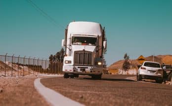 white freight truck on grey concrete road